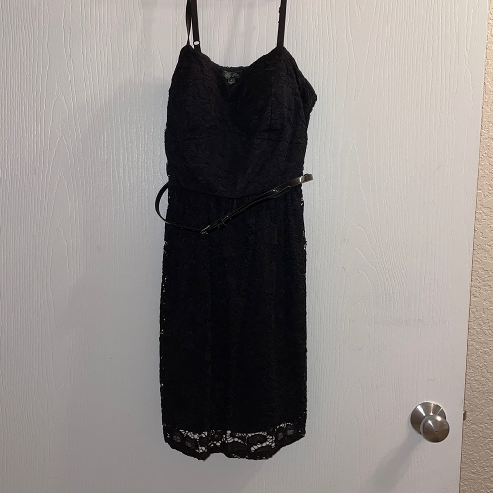 Black cocktail dress with a lace over lay and a belt